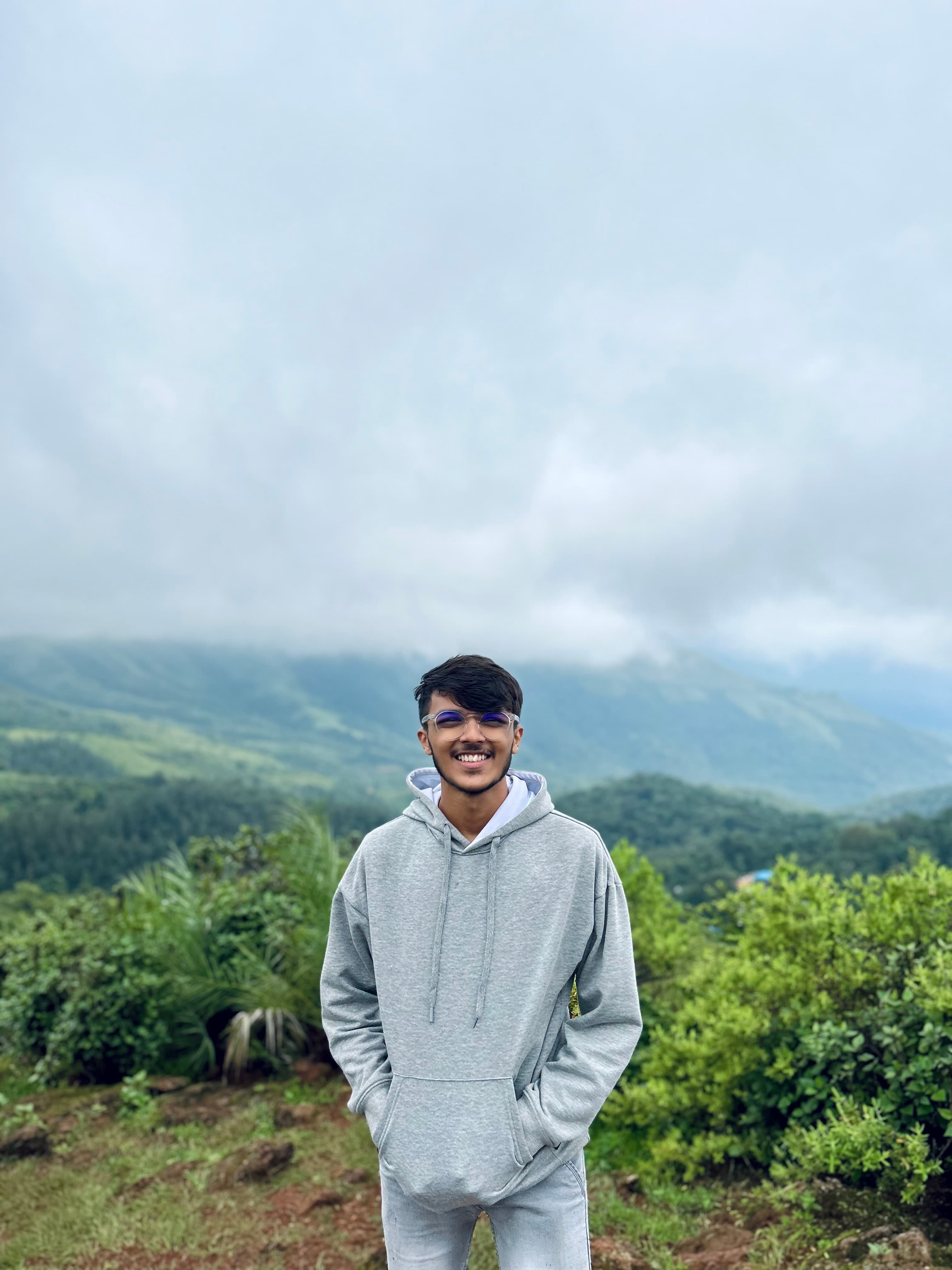 Thilak S enjoying a serene mountain landscape.